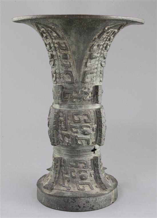 A Chinese archaic bronze ritual wine vessel, Zun, late Shang/early Western Zhou dynasty, 35.5cm high, split to foot